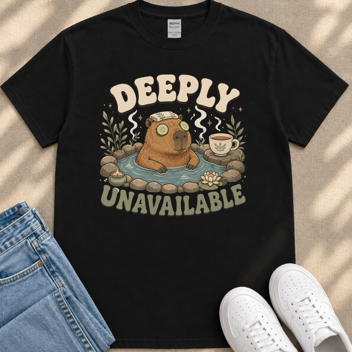 a black t-shirt with a graphic design depicting a cartoon beaver in a hot tub, surrounded by various objects such as a cup, a towel, and a pair of sunglasses. The text on the t-shirt reads "DEEPLY UNAVAILABLE".