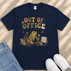 A navy blue t-shirt with a colorful graphic design depicting a frog sitting on a laptop, surrounded by various office-related items such as a calendar, a phone, and a coffee mug.