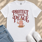 A white t-shirt with a graphic design featuring a candle and the text "PROTECT YOUR PEACE" printed on it.