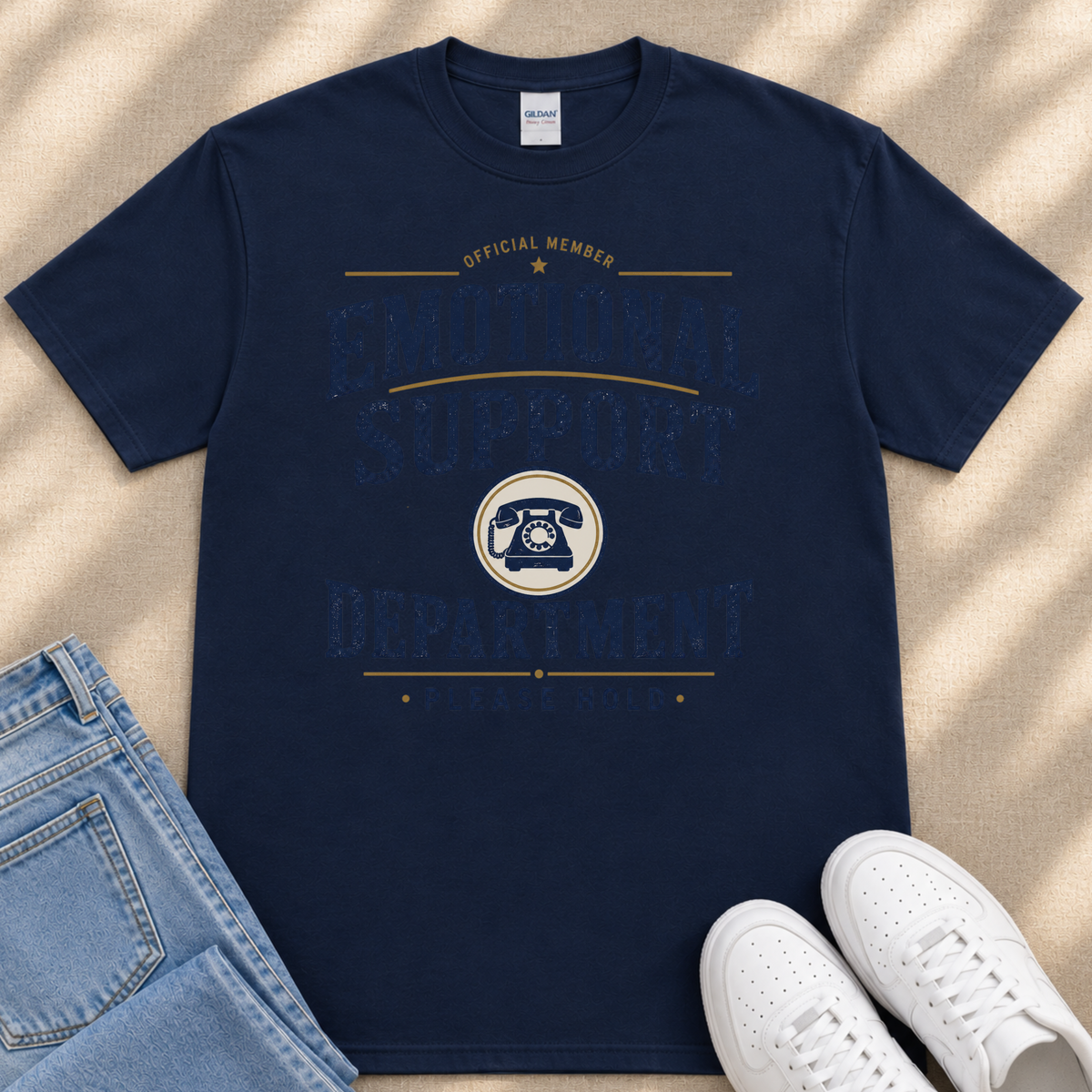 a navy blue t-shirt with a graphic design, a pair of blue jeans, and a pair of white sneakers.