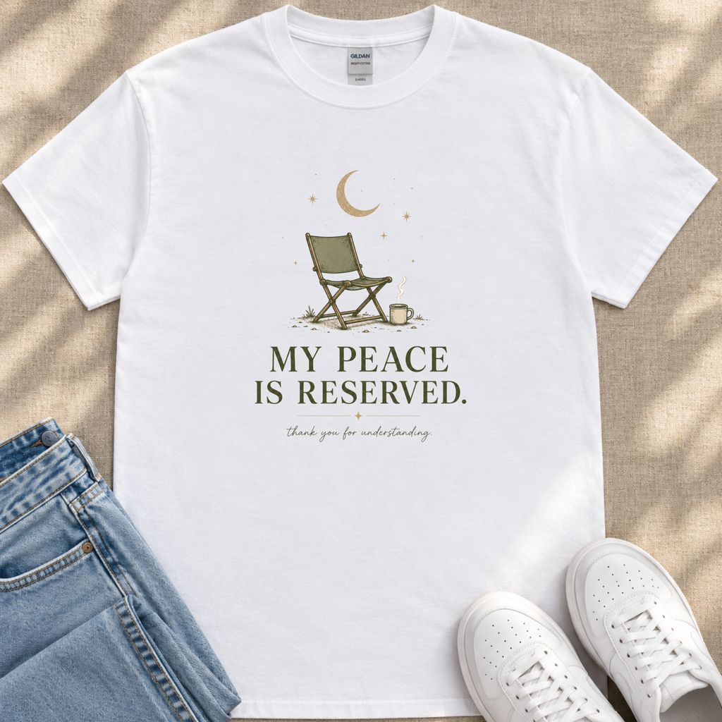A white t-shirt with a graphic design and text printed on it, along with a pair of jeans and white sneakers.