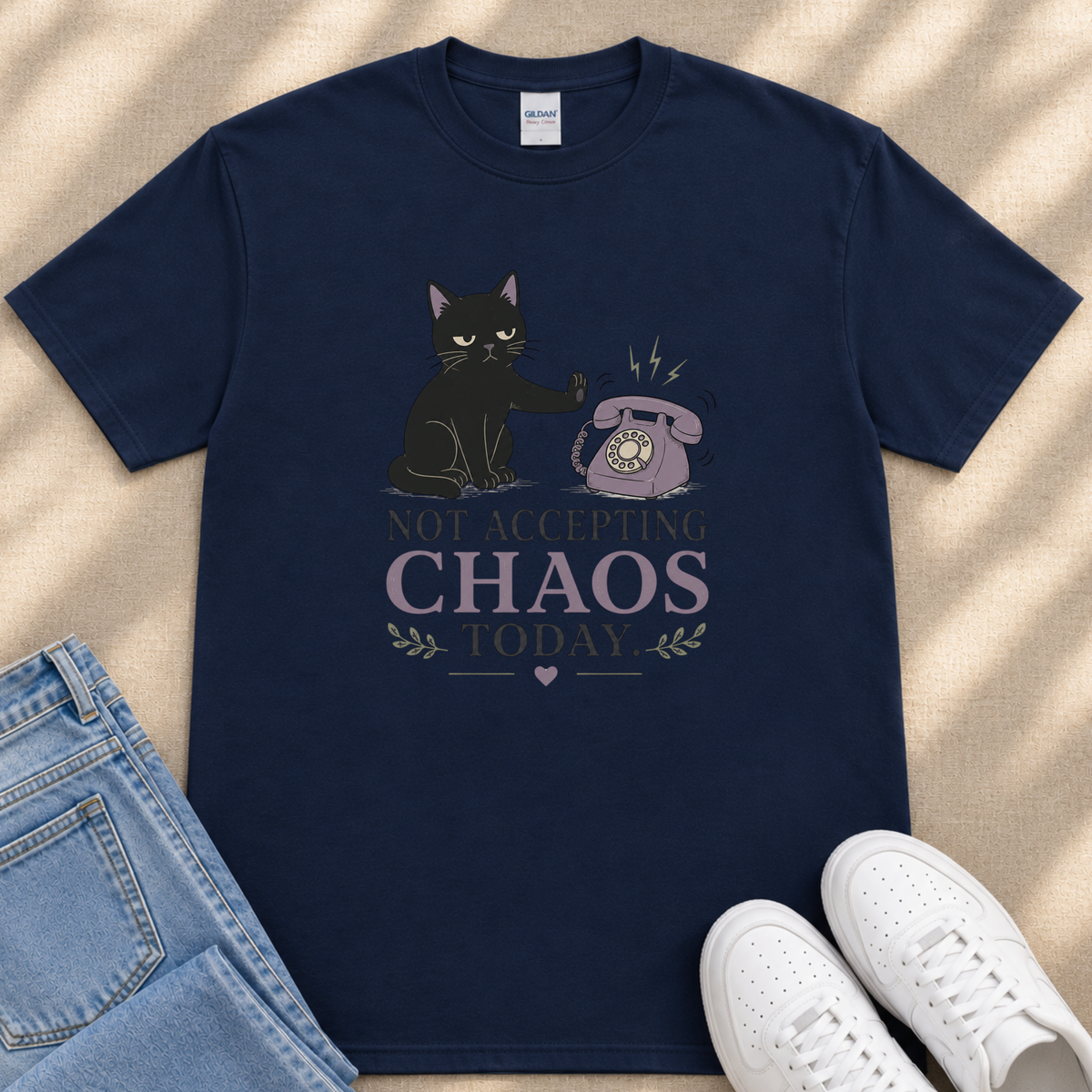 A navy blue t-shirt with a graphic design depicting a black cat and a telephone, along with the text "NOT ACCEPTING CHAOS TODAY".