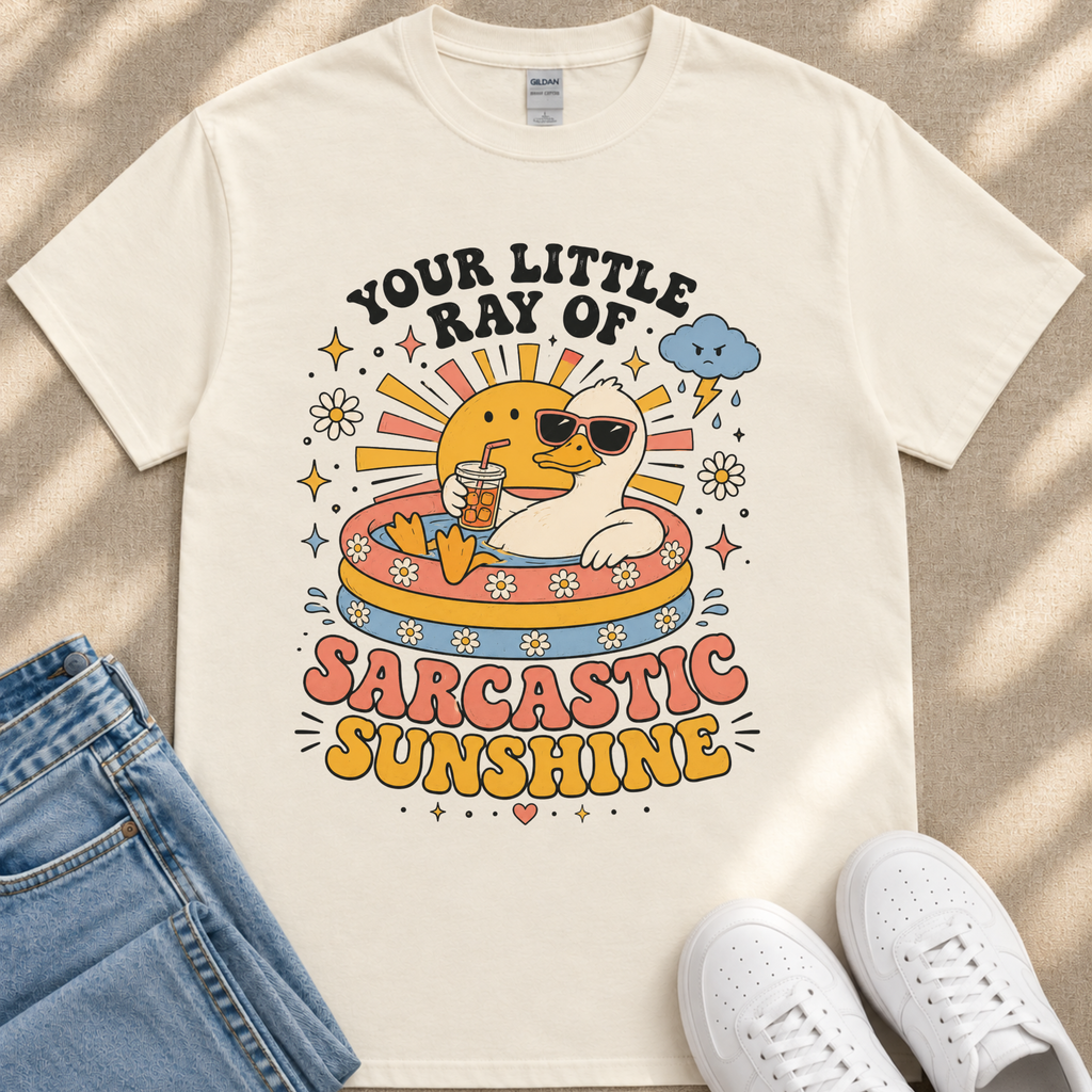 A white t-shirt with a colorful graphic design depicting a duck wearing sunglasses and surrounded by various sun-related elements, such as a cloud, sun, and flowers.