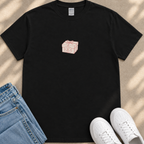 a black t-shirt with a small graphic of a gift box on it, along with a pair of blue jeans and white sneakers.