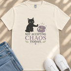 A white t-shirt with a graphic design depicting a black cat and a telephone, along with the text "NOT ACCEPTING CHAOS TODAY".