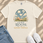 A white t-shirt with a graphic design depicting a rabbit in a field under a starry sky, along with the text "LEAVE ROOM FOR GOOD THINGS".