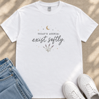 A white t-shirt with a printed design and text, along with a pair of jeans and white sneakers, laid out on a surface.