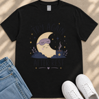 A black t-shirt with a graphic design depicting a crescent moon, a sleeping person, and stars, along with the text "TRY AGAIN AFTER REST".