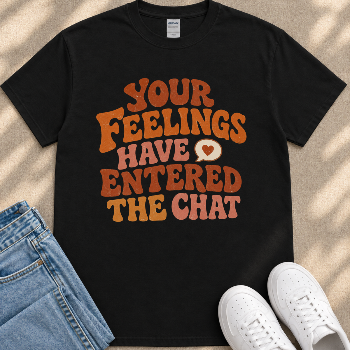 A black t-shirt with a colorful text design that reads "Your Feelings Have Entered The Chat" in a retro style.