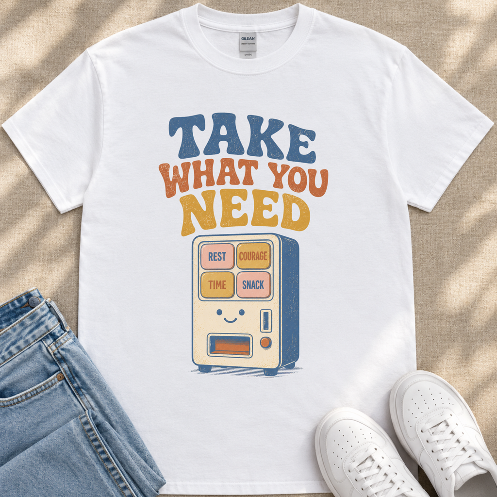 A white t-shirt with a graphic design featuring a vending machine and the text "TAKE WHAT YOU NEED" printed on it.