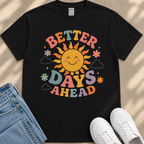 A black t-shirt with a colorful graphic design featuring a smiling sun and the text "Better Days Ahead" printed on it.