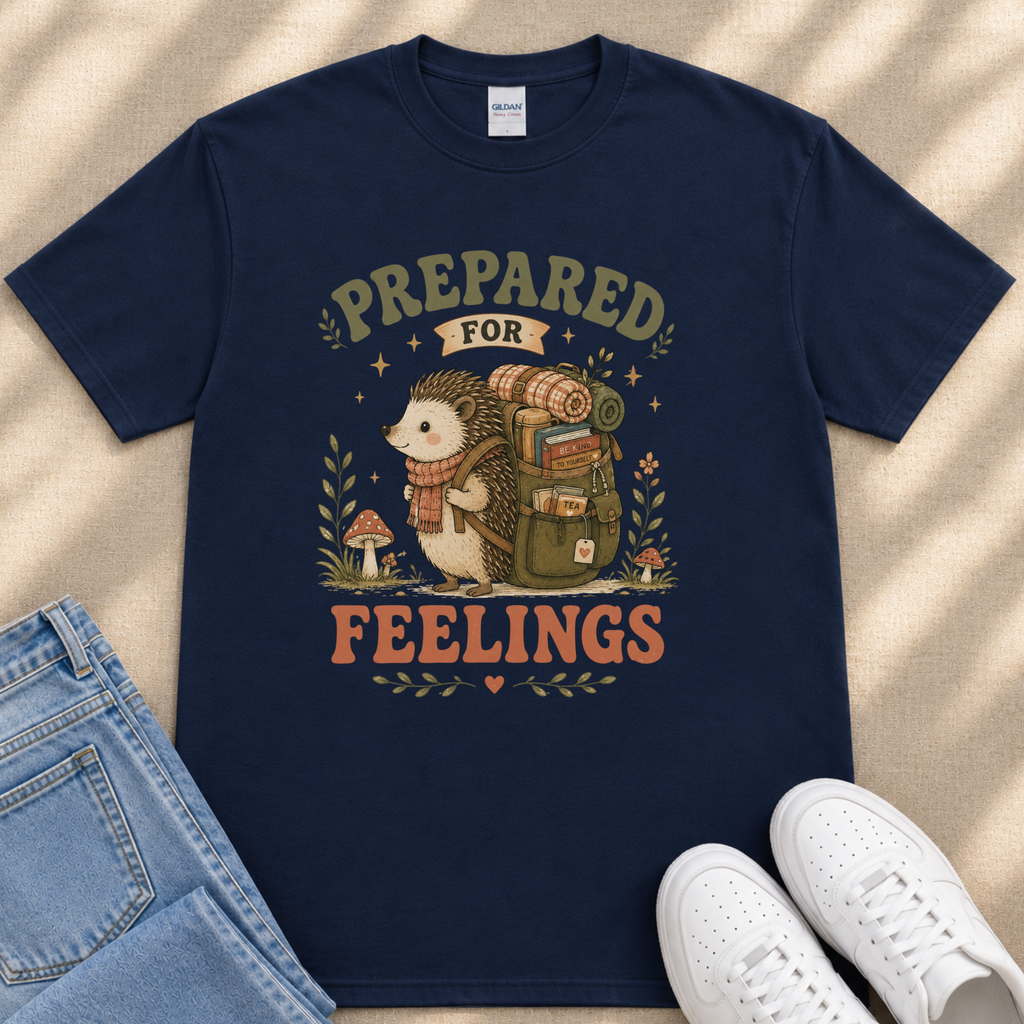 A navy blue t-shirt with a graphic design depicting a hedgehog carrying a backpack and the text "PREPARED FOR FEELINGS" printed on it.