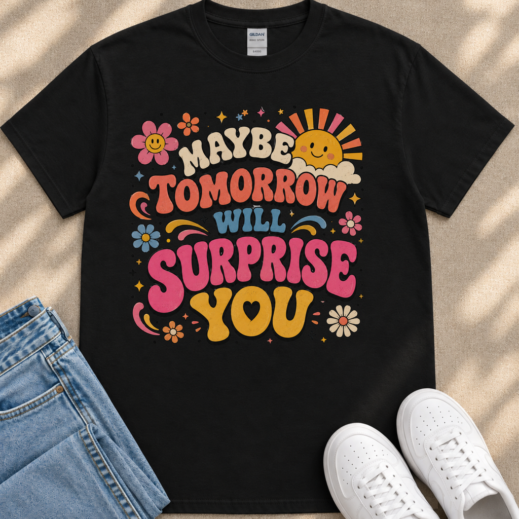 A black t-shirt with a colorful graphic design featuring text and various decorative elements such as flowers, stars, and a sun.
