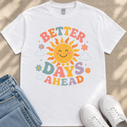A white t-shirt with a colorful graphic design featuring a smiling sun and the text "Better Days Ahead" printed on it.