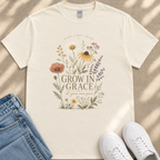 A white t-shirt with a floral design and the text "Grow in Grace" printed on it, along with a pair of jeans and white sneakers.
