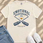 A white t-shirt with a graphic design featuring a crossed wrench and the text "Emotional Maintenance Co."