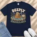 A navy blue t-shirt with a graphic design featuring a cartoon beaver in a hot tub, surrounded by various objects such as a cup, a plant, and a pair of jeans.