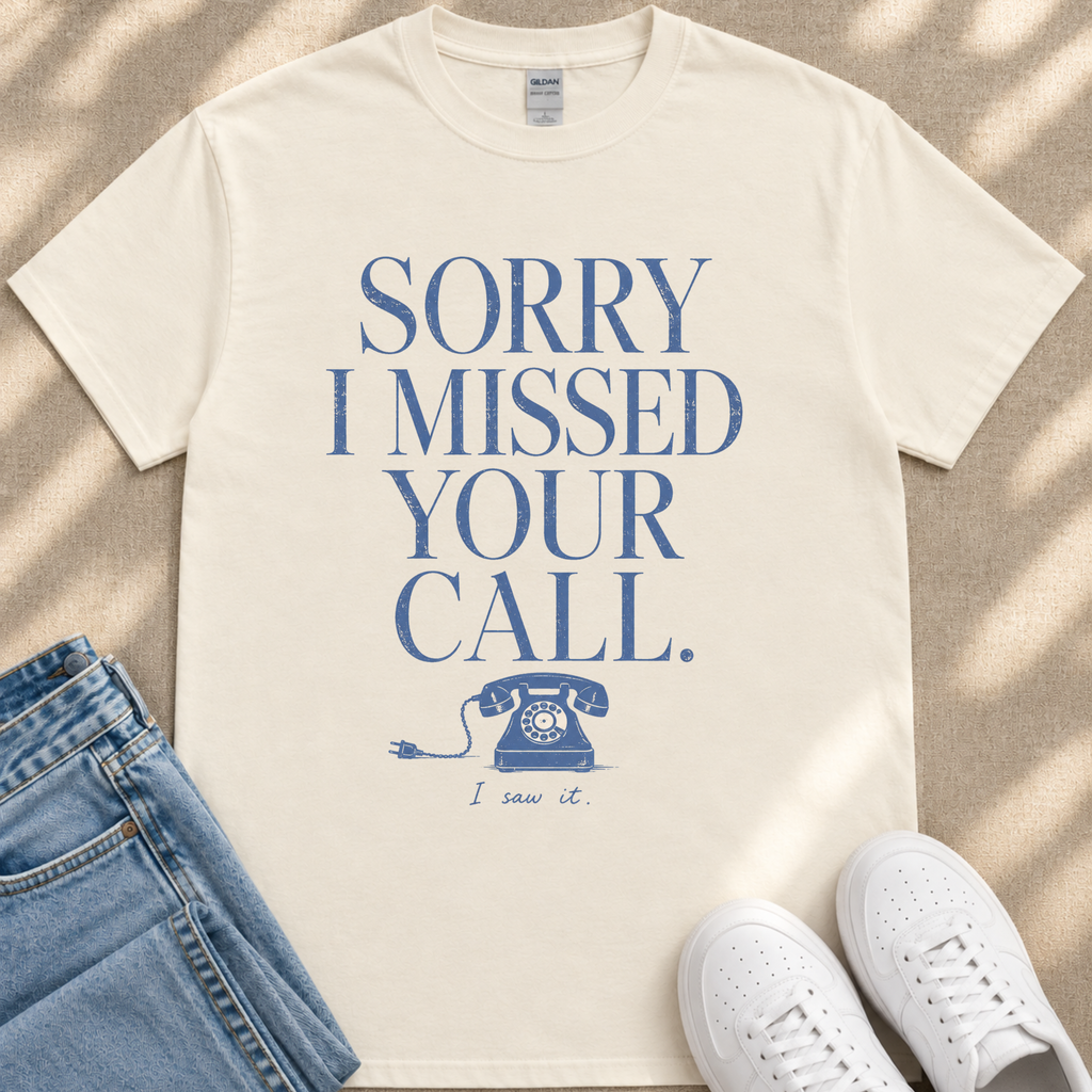 A white t-shirt with a humorous text printed on it, along with a pair of jeans and white sneakers.