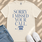 A white t-shirt with a humorous text printed on it, along with a pair of jeans and white sneakers.