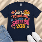 A navy blue t-shirt with a colorful graphic design featuring text and illustrations, along with a pair of jeans and white sneakers.