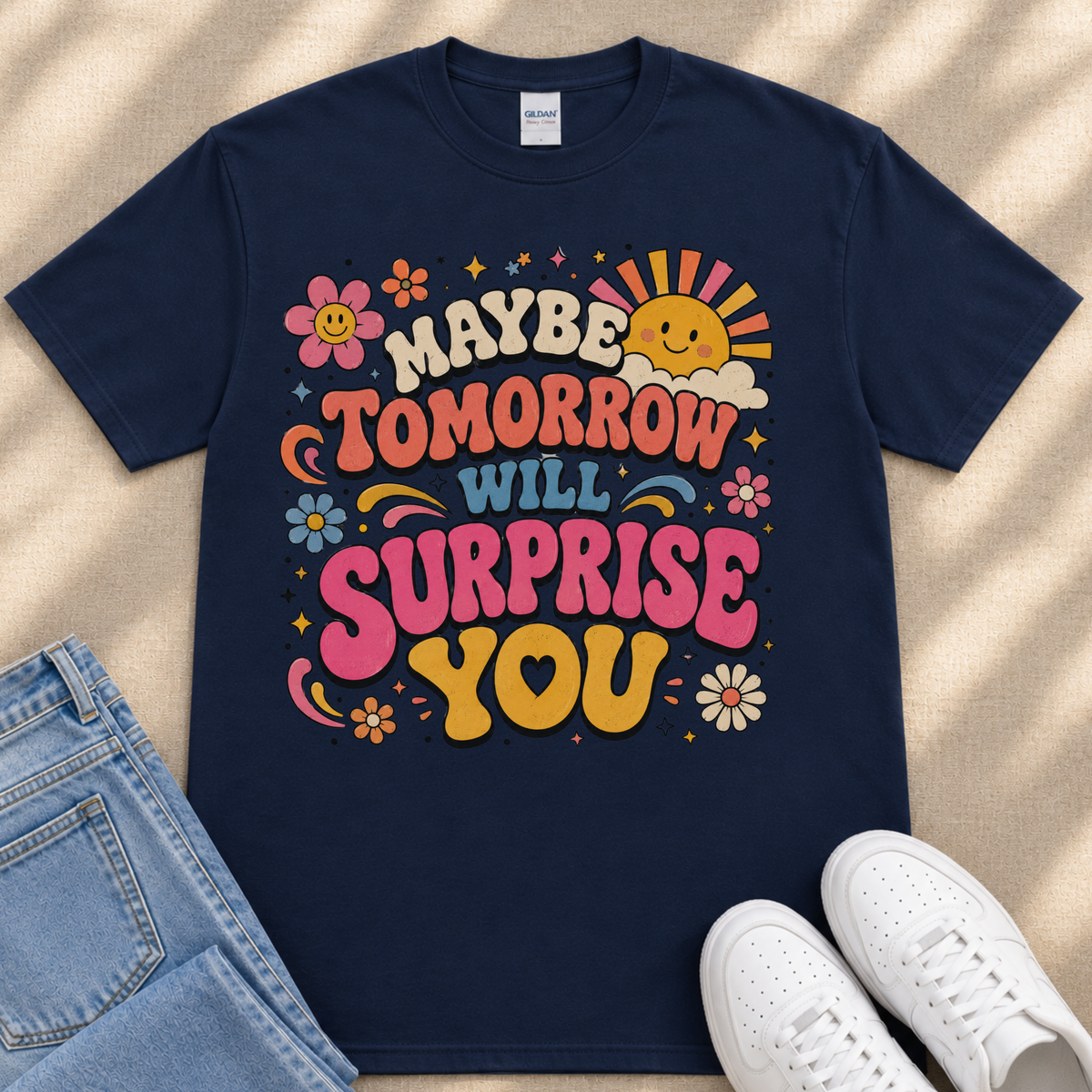 A navy blue t-shirt with a colorful graphic design featuring text and illustrations, along with a pair of jeans and white sneakers.