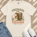 A white t-shirt with a graphic design depicting a hedgehog carrying a backpack and the text "PREPARED FOR FEELINGS" printed on it.