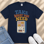 A navy blue t-shirt with a graphic design featuring a vending machine with the text "TAKE WHAT YOU NEED" printed on it.