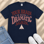 A navy blue t-shirt with a humorous text printed on it, along with a pair of jeans and white sneakers.