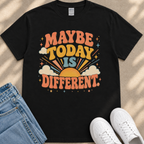A black t-shirt with a colorful graphic design that says "MAYBE TODAY IS DIFFERENT" along with a sun and clouds design.