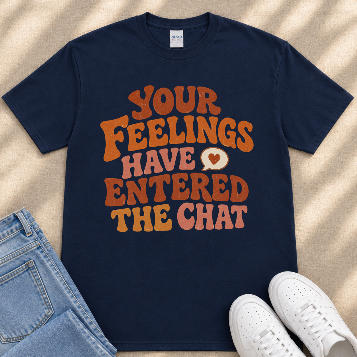 A navy blue t-shirt with a colorful text design that reads "Your Feelings Have Entryed The Chat" in orange and pink letters.